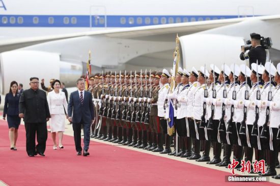 9月18日，韩国总统文在寅抵达朝鲜平壤，朝鲜最高领导人金正恩携夫人李雪主到机场迎接。图为文在寅与金正恩检阅朝鲜仪仗队。